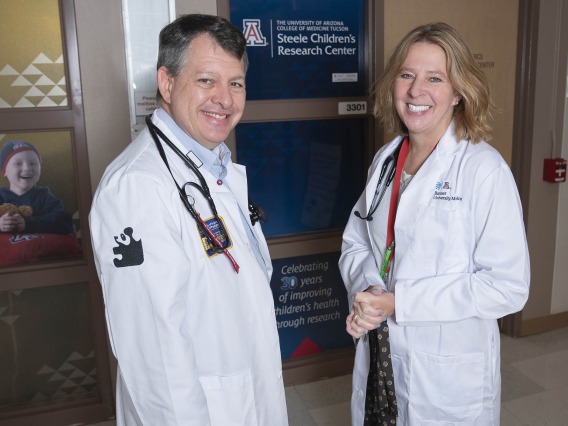 Michael Daines, MD, and Cori Daines, MD, outside the Steele Children’s Research Center, where the husband and wife have made their careers as pediatric physician-scientists since 2007.