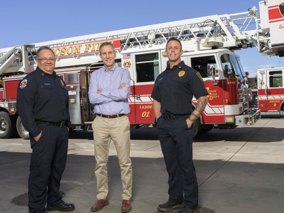 (From left) Tucson Fire Capt. John Gulotta, professor Jeff Burgess, MD, MS, MPH, and Chief Paul Moore have worked closely for 30 years to help reduce risks to firefighter health in Tucson and around the globe.