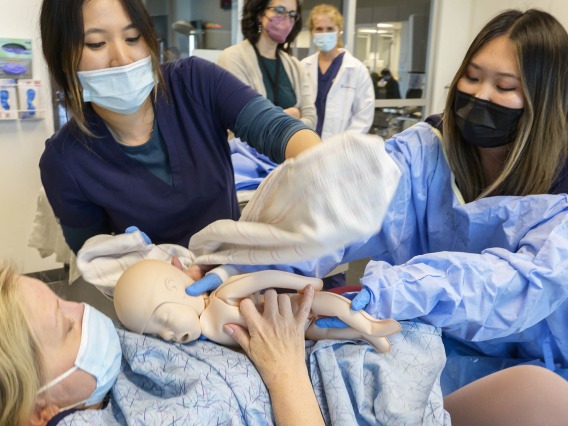 University of Arizona College of Nursing Doctor of Nursing Practice students deliver a manikin baby during a clinical immersion session.