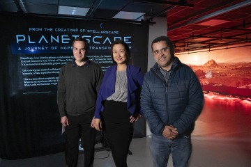 group portrait of Peter Torpey, Yuanyuan Kay He and Gustavo de Oliveira Almeida in PlanetScape immersive art exhibit 
