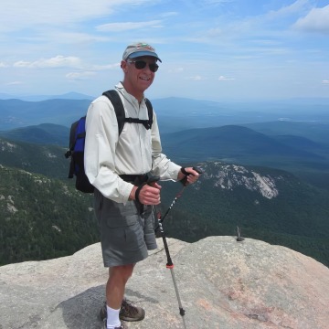 candid photo of george Vanderheiden hiking on a mountaintop