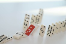 A line of dominoes representing a chain reaction