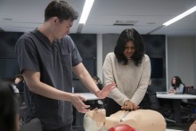 University of Arizona College of Medicine – Phoenix student James Bates teaches high school student Maalavika Menon how to do CPR.