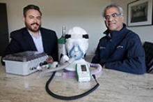 Manny Teran, chief executive officer of SaiOx, left, and Dr. Sairam Parthasarathy, professor of medicine at the University of Arizona, pose with the Hespiro, a rebreathing and low-pressure device to aid people with respiratory problems. (Photo: Courtesy of Arizona Daily Star/Mamta Popat)