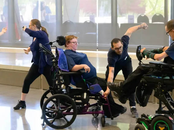 A group of dancers, two in wheelchairs, perform an interpritive dance. 