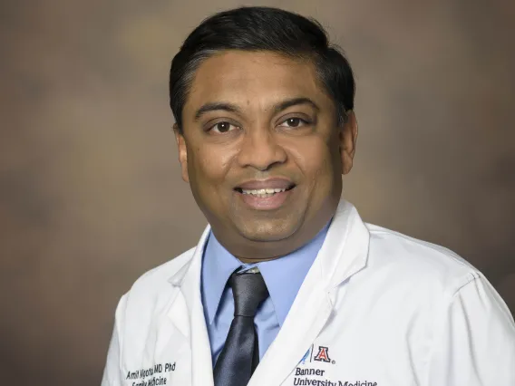 Portrait of Dr. Amit Algotar from the University of Arizona College of Medicine – Tucson wearing a white physician’s coat.