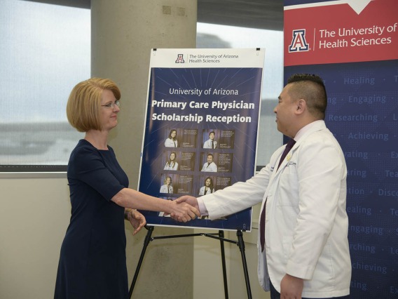 Rep. Heather Carter shakes hands with  Primary Care Physician scholarship recipient Jasper Puracan. 