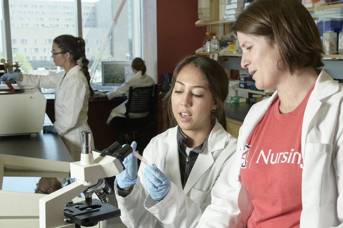 Female nursing professor and female student in a lab.