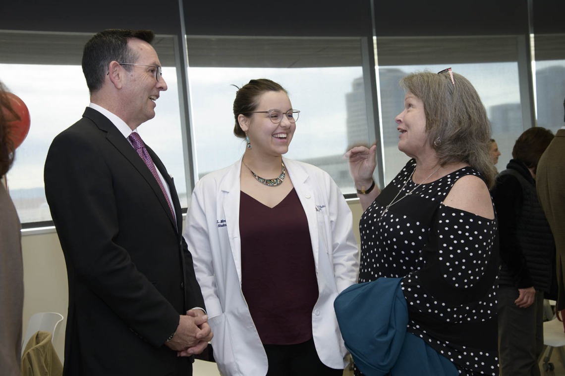 College of Medicine - Phoenix Associate Dean of Admissions and Recruitment Glen Fogerty, PhD, MBA, and Primary Care Physician scholarship recipient Kathryn Blevins talk with her family.