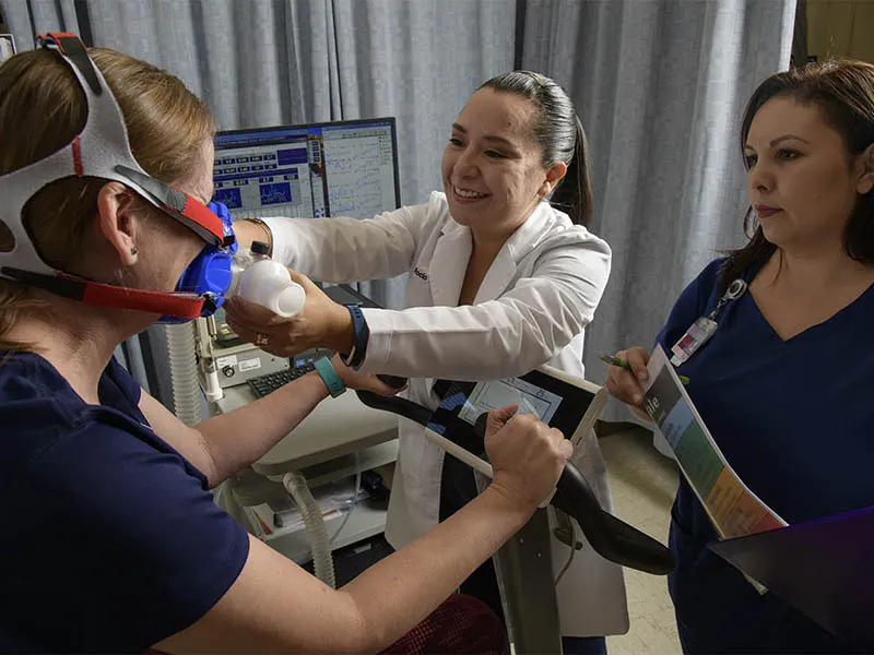 care team attaches breathing machine to patient