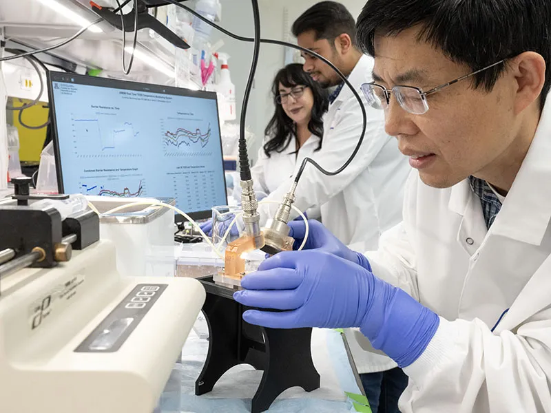 lab researchers using microscope