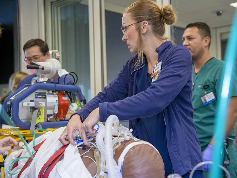 clinical instructor demonstrating procedure on mannequin