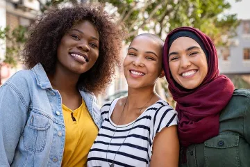 three multi-ethnic women smiling