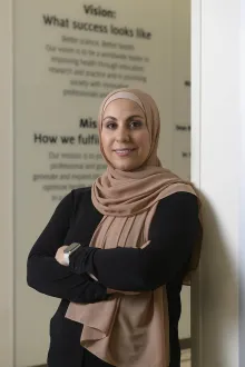 Diyana Ahmad, a second-year student at the Coit College of Pharmacy, poses inside the hallway of the Coit College of Pharmacy.