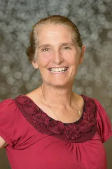 Portrait of Lisa Kiser standing in the Health Sciences Innovation Building.