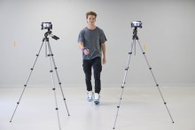 a study participant walking toward two cameras set up on tripods in an empty room at the University of Arizona Health Sciences